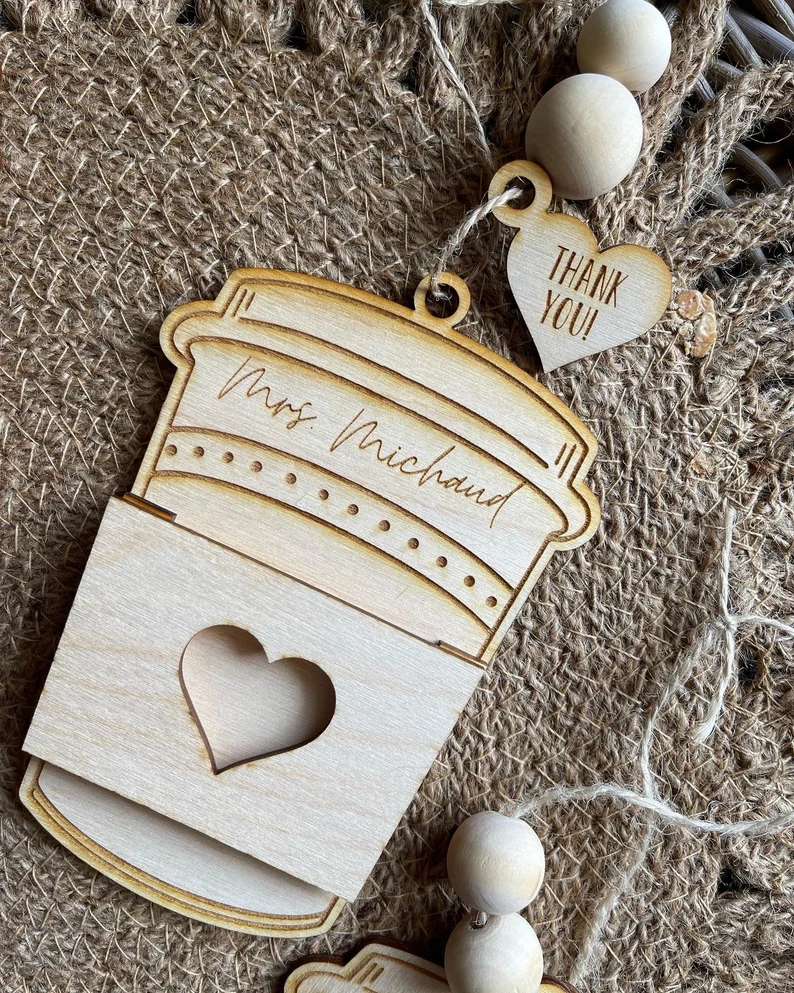 A wooden engraved gift card holder is made to look like a coffee cup.