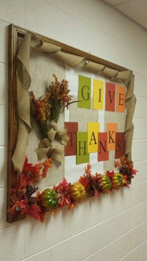 Fall bulletin boards can include 3-D pumpkins, leaves, and flowers like this one. Text reads Give thanks in big letters.