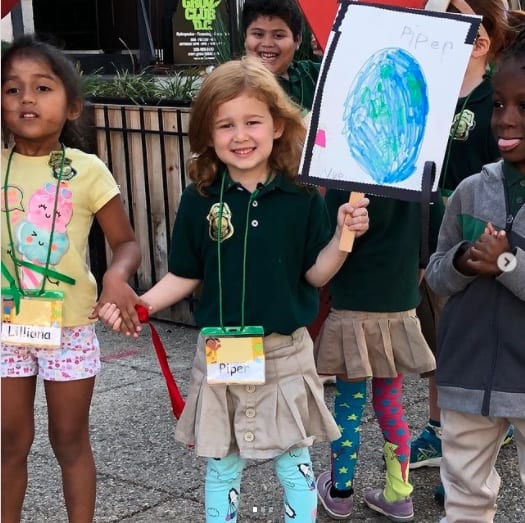 Young children holding Global Climate Change Strike signs