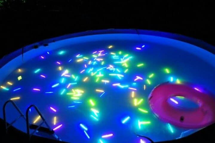 glow sticks in a kiddie pool for a water activity 