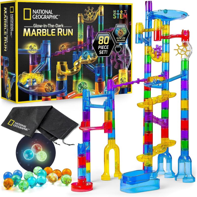 Many multi-colored pieces come together to form an obstacle course for marbles. A game box is also shown and a box of marbles.