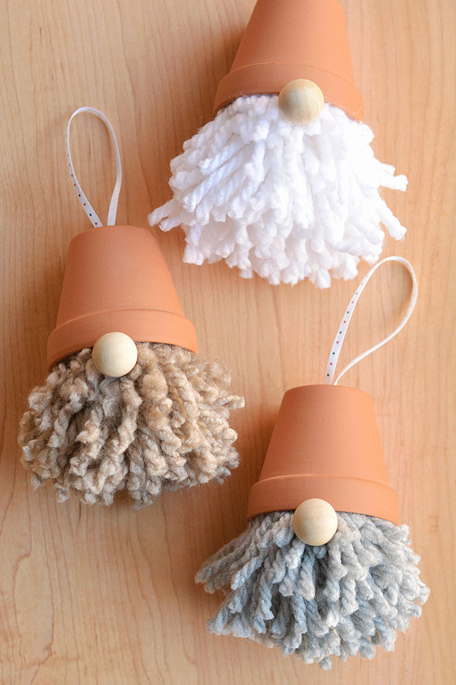 Gnome ornaments made from tiny clay pots, yarn and pom poms