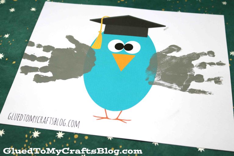 Preschool graduation ideas include crafts like this one that include a blue circle with two handprints coming off the sides that are supposed to be the owl's arms. It has a face and a graduation cap on.