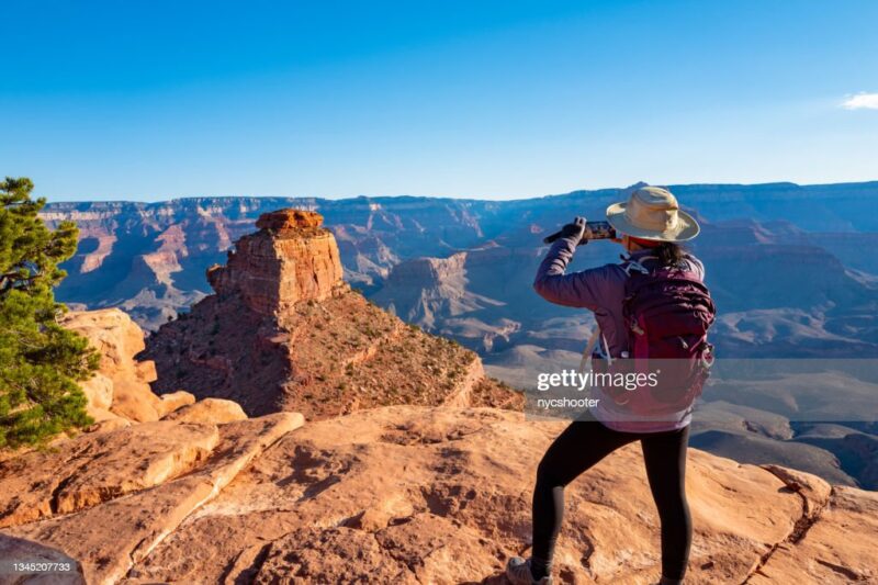Woman looking out over a cliff at Grand Canyon National Park, as an example of virtual fifth grade field trips