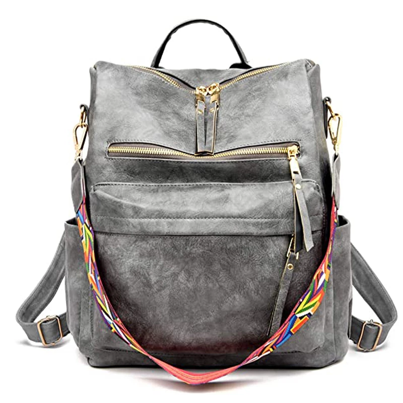 Vegan leather grey backpack with patterned strap, top zipper, and multiple external pockets