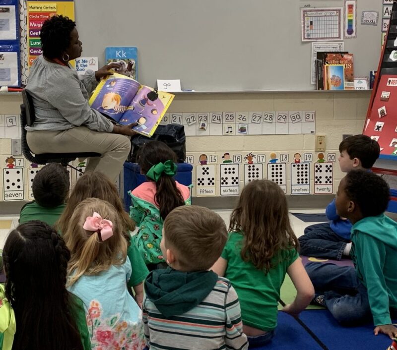 guest reader reading to a class of students for a fun friday activity