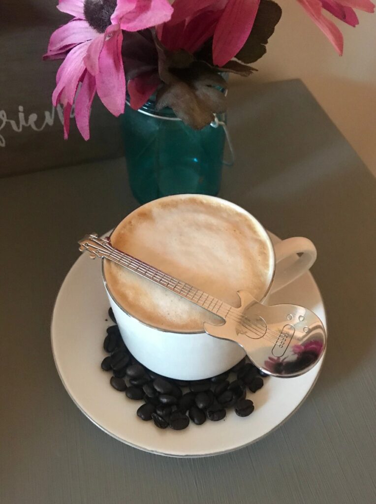 Guitar-shaped spoon on a cup of coffee