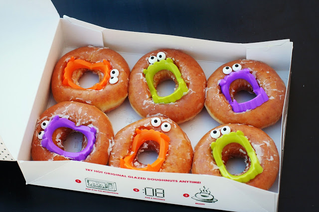 box of doughnuts with vampire teeth and eyes for a halloween teacher's gift 