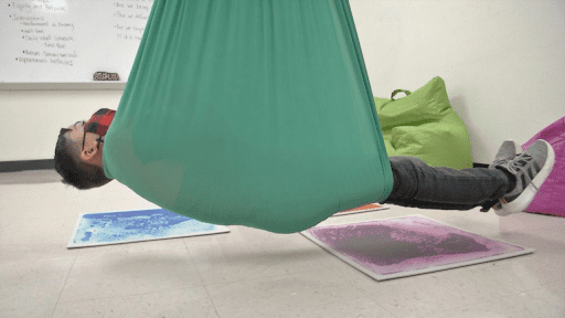 Person laying in hammock, as an example of sensory room ideas