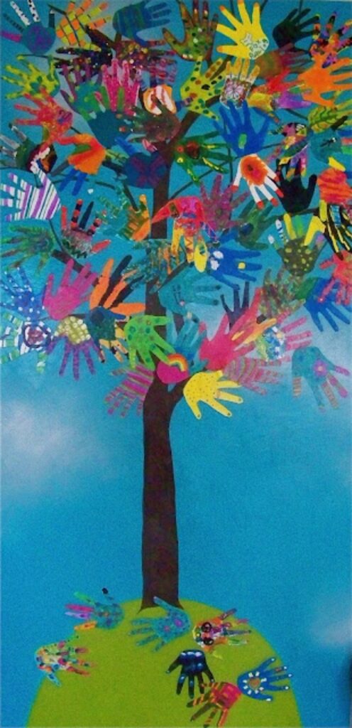 A tree with leaves made from children's handprints against a bright blue background