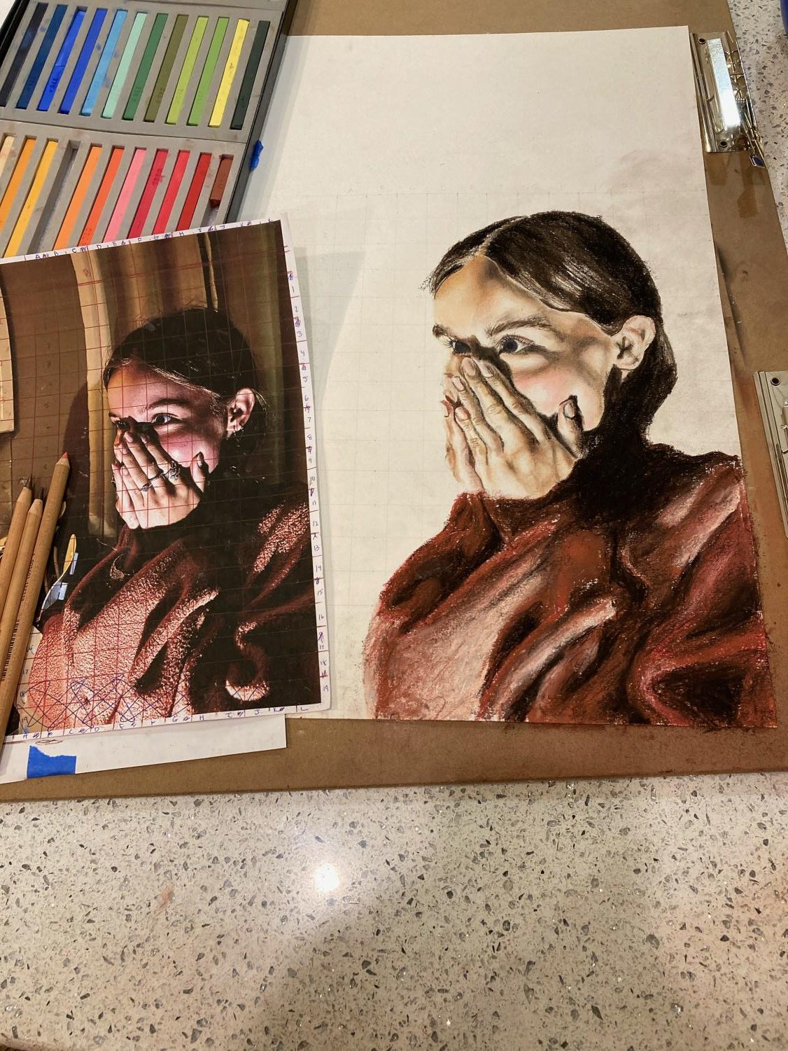 A colored pencil and pastel portrait of a girl covering her mouth with her hands (AP art portfolio examples)