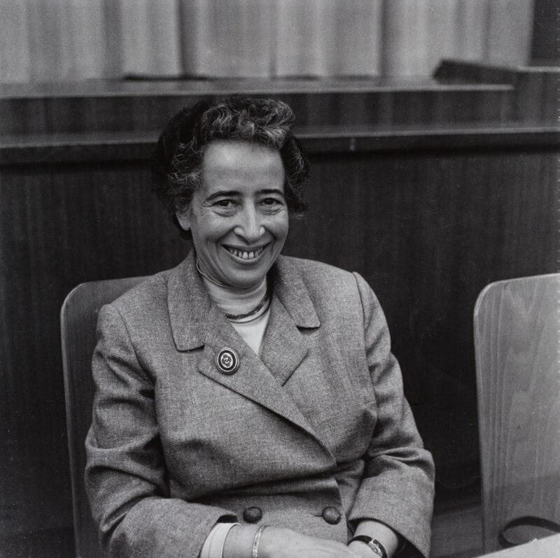 An older woman is seen sitting in a black and white photo.