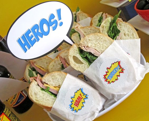 hero sandwiches wrapped in paper with a note that says heros!