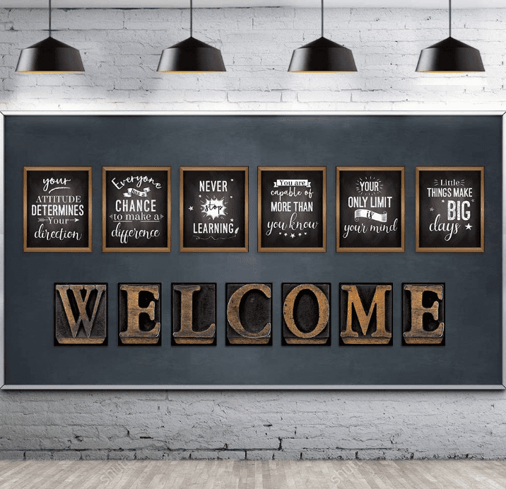 Several wall hangings on a dark blue wall with motivational sayings and letters that spell out the word 'WELCOME.'