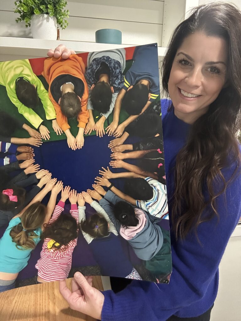 hilary-holding-heart-in-classroom Hilary holding heart