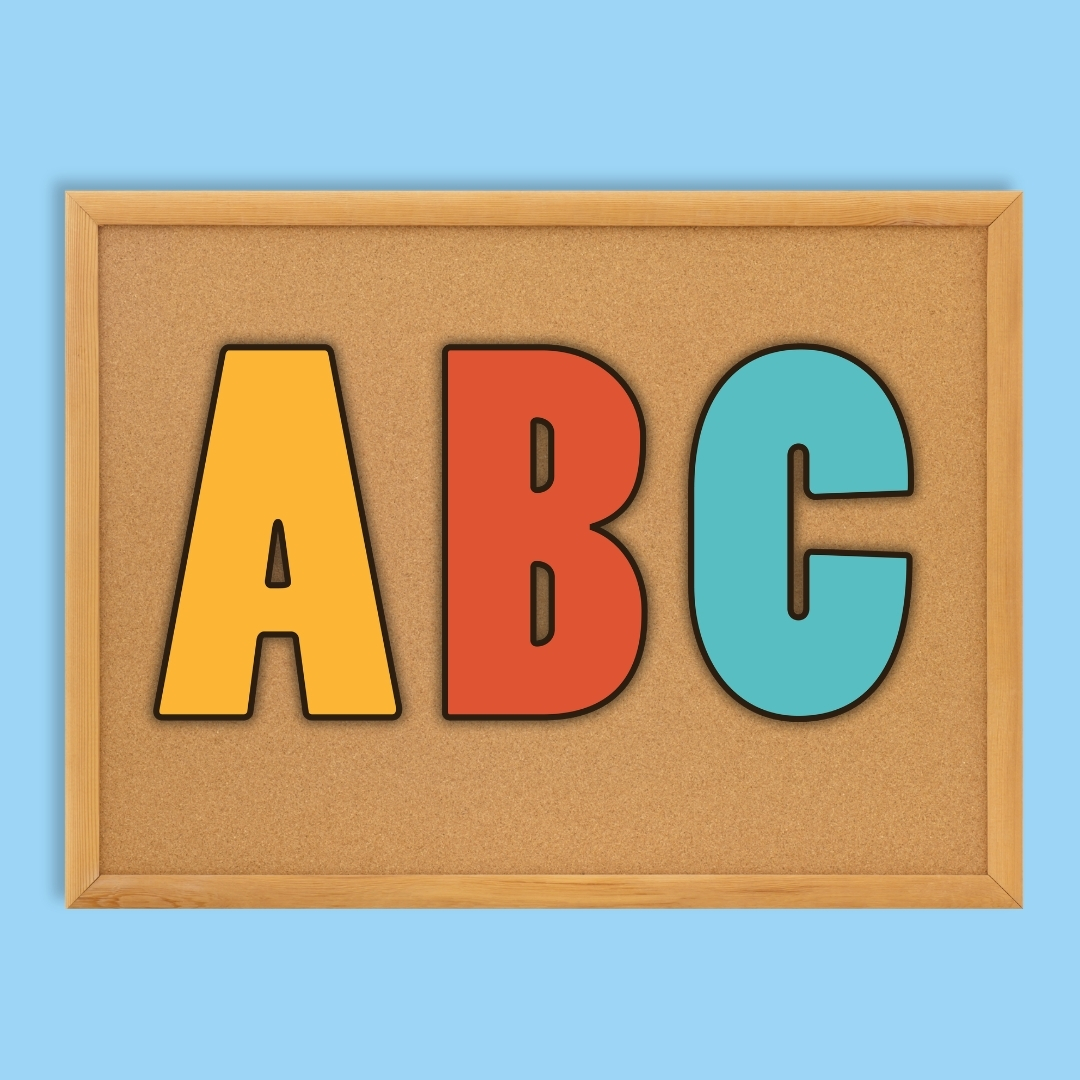 Hispanic Heritage Month bulletin board kit alphabet letter cutouts in yellow, orange, and teal on a cork board