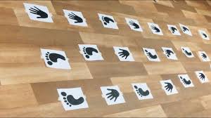 Print-outs of hands and feet on floor