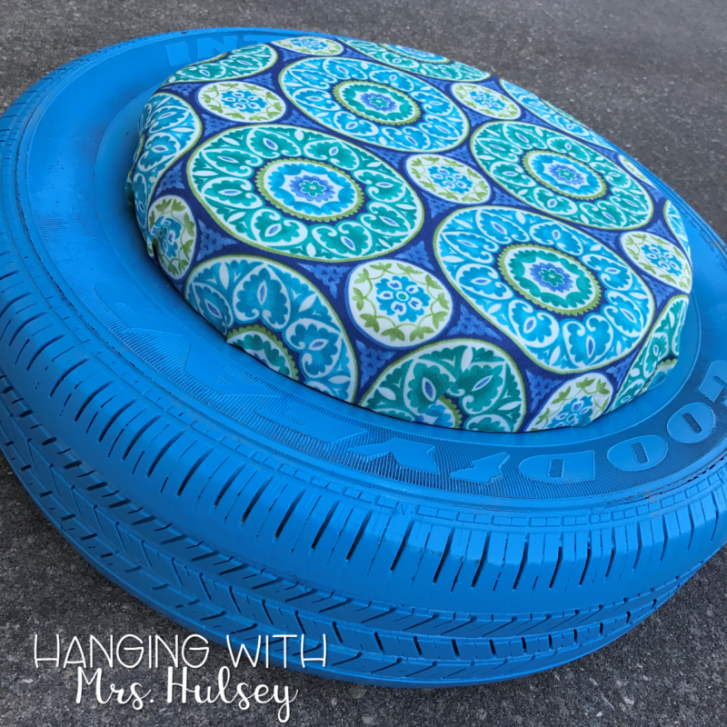 A tire painted blue with a blue floral cushion in the middle makes a handy seat