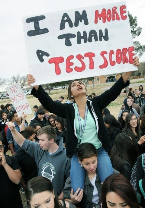 Student holding sign that says I am more than a test score