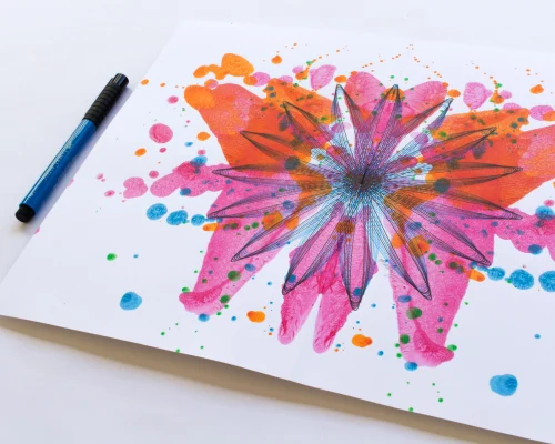 A beautiful abstract painting is created by blotting paint on a piece of paper then folding it in half