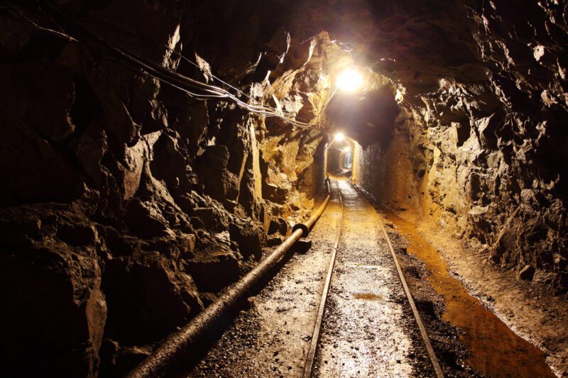 Railway running through dimly lit mine shaft