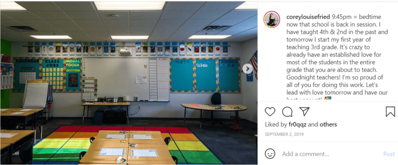 Colorful rainbow carpet and desks in a third grade classroom