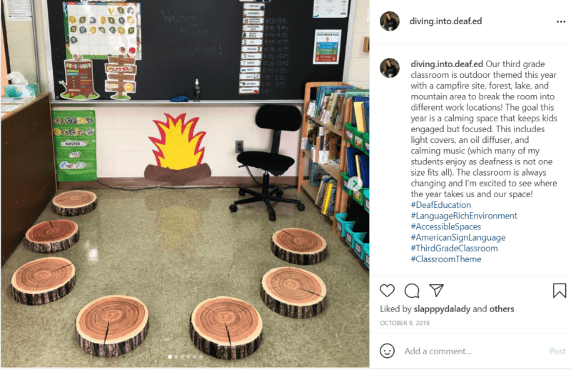 Tree stumps with fake campfire around the blackboard in a classroom