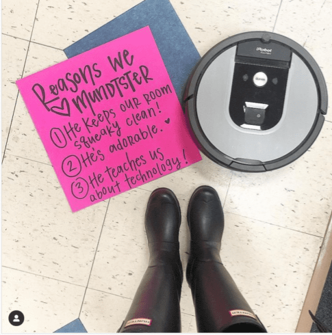 A teacher's boots stand over a note and an iRobot. The note says REasons we love mundster.