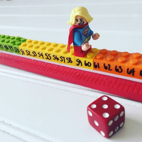 Instagram-worthy teacher hacks inlcude Legos that are attached together with numbers written on them. A Lego minifgure is on top of it and a dice is also pictured.