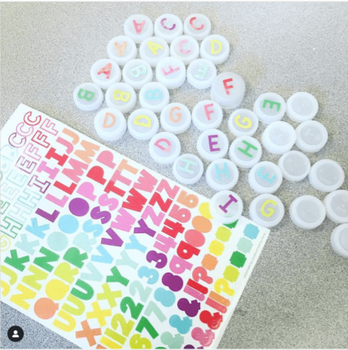 Instagram-worthy teacher hacks include bottle caps that have letter and number stickers on them like the ones shown.