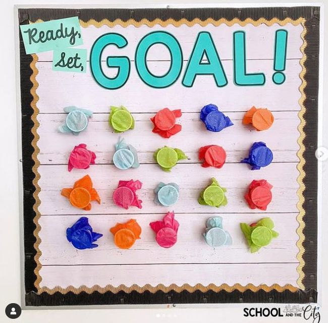 Ready Set Goal bulletin board with cups covered with tissue paper that can be punched out to find prizes
