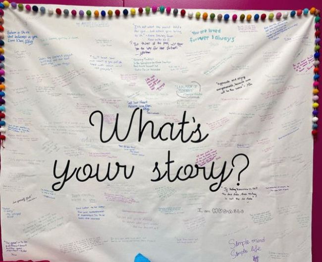 What's Your Story bulletin board where students have written their own small stories onto the board