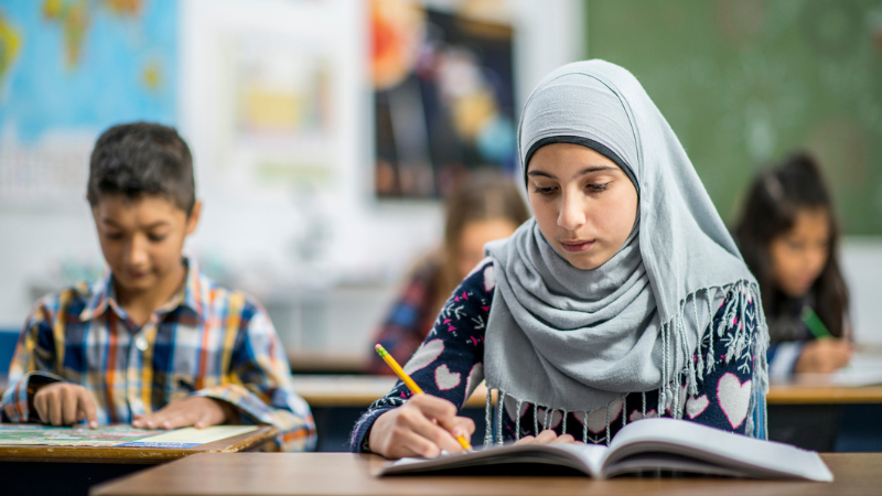 Muslim student in a headscarf in class