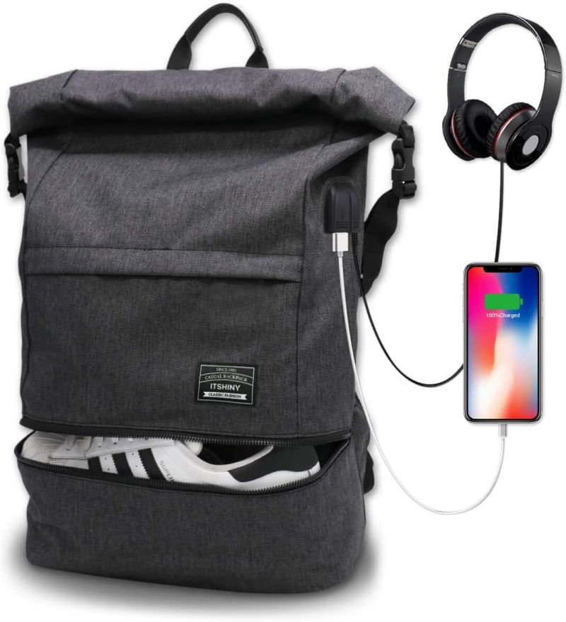 Roll-top black backpack with separate shoe compartment at the bottom, plus a port attached to a cell phone and headphones