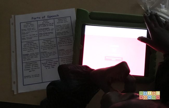 Student playing a Kahoot game with an accompanying worksheet