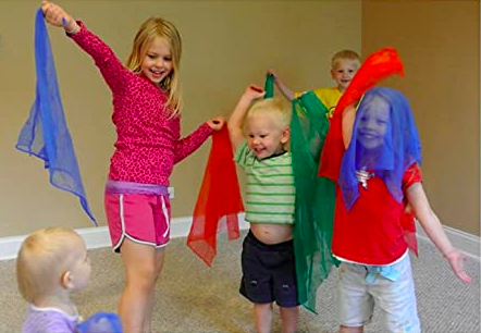 kids playing with silk scarves as an example of indoor recess games and activities