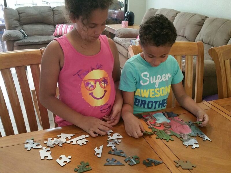 kids putting together a puzzle for a fun friday activity