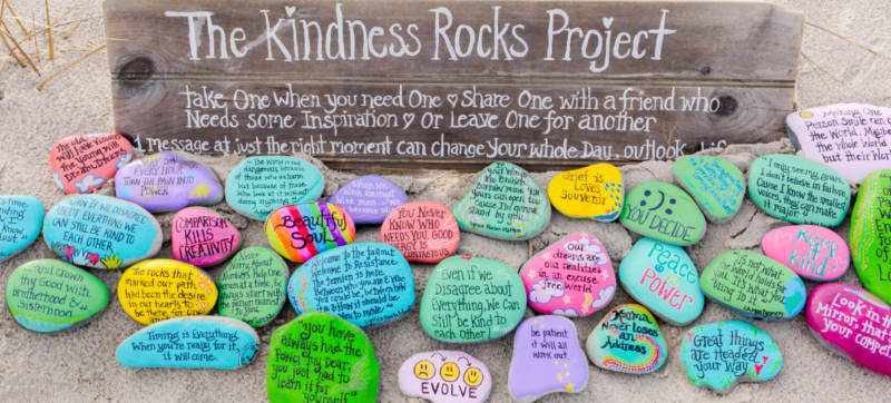 A beautiful display of rocks painted with colorful messages as an example of school spirit ideas