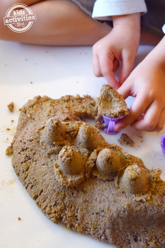 Person playing with kinetic sand- summer activities for kids