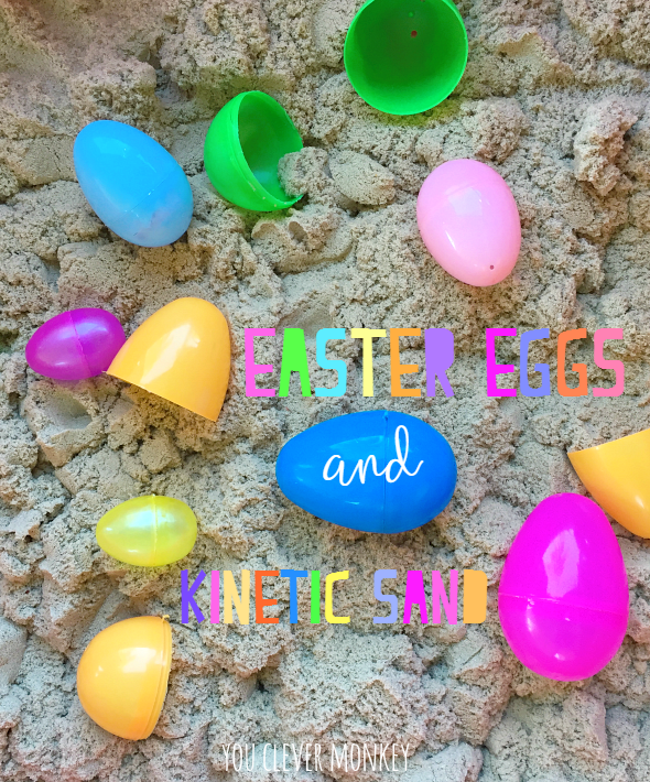 Plastic easter eggs are laid out around kinetic sand. 