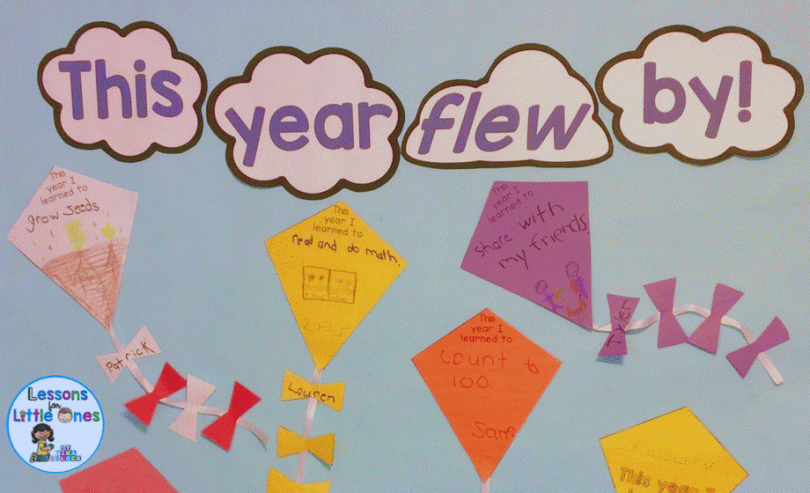 Text in clouds reads This year flew by. Kites are attached to the board that have writing prompts and drawings on them. 