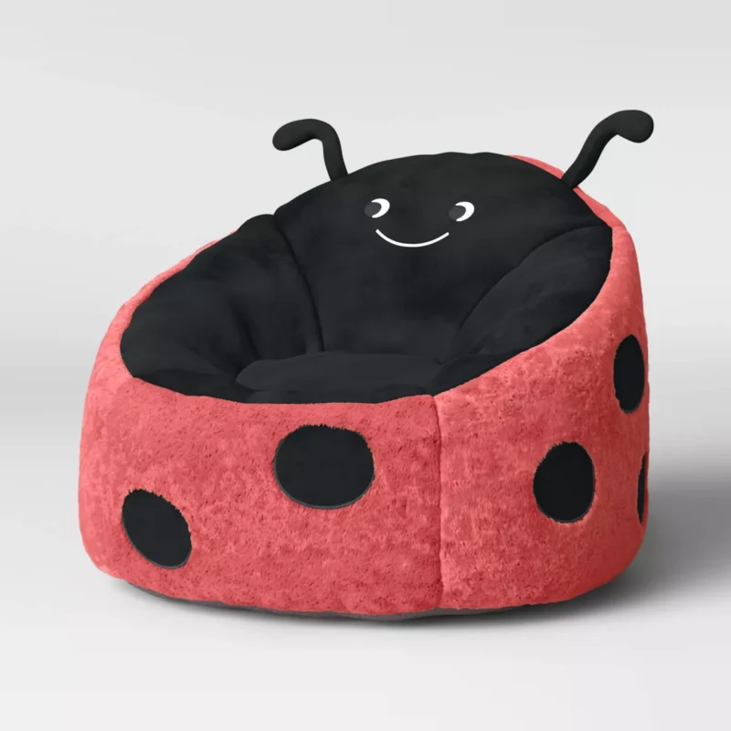 A bean bag chair is designed to look like a lady bug.