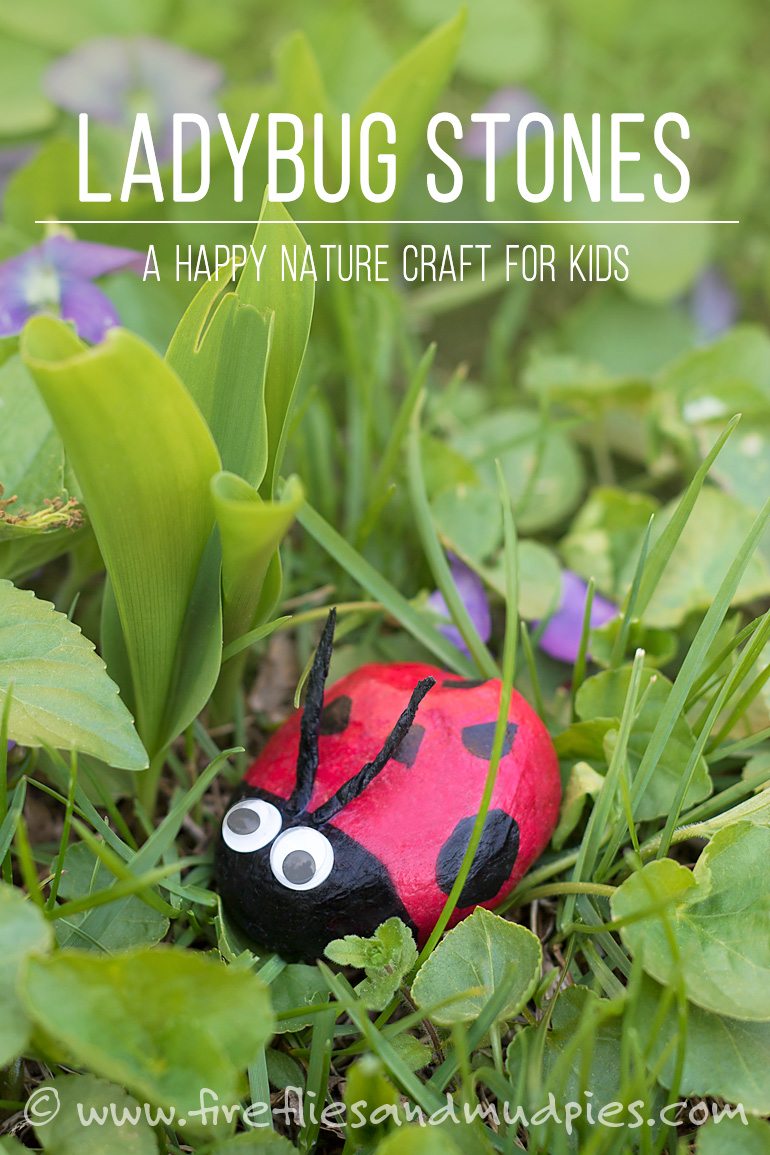 A stone is painted to look like a ladybug and is placed in a garden (spring crafts for kids)