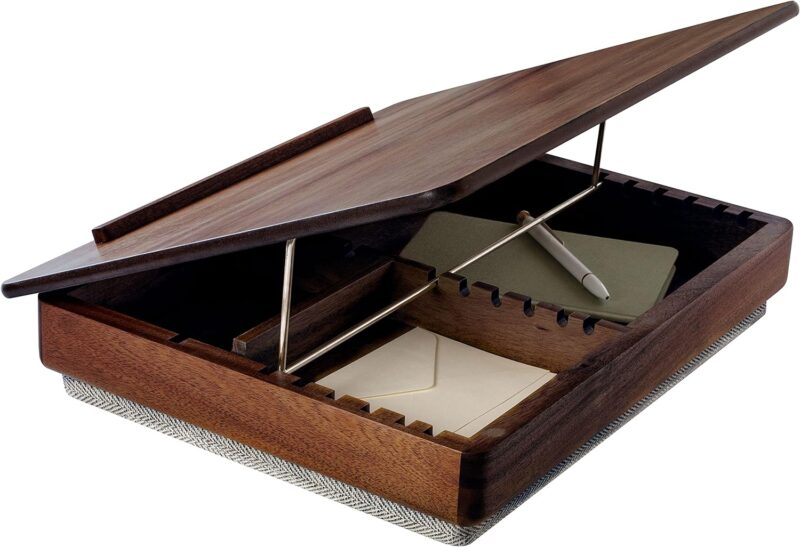 A wooden lap desk is opened to reveal storage underneath