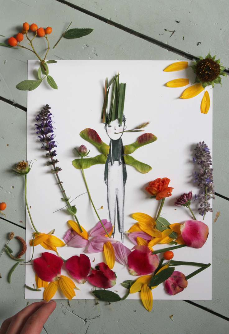 A simple marker drawing of a boy is in the center of the page and leaves and flower petals have been glued around him including to form his arms and hair. 