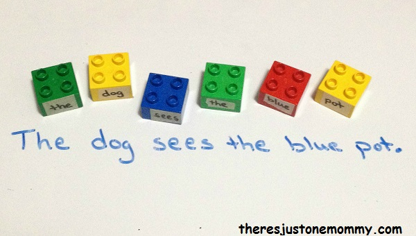 Colorful lego blocks with a word taped to each laid out to form a sentence when playing grammar games
