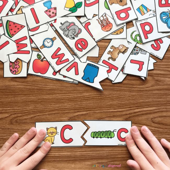 Student matching upper and lowercase C printable puzzle pieces (Letter Naming Fluency)