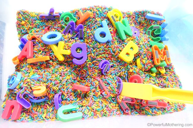 Plastic bin full of colored rice and magnetic alphabet letters (Letter Naming Fluency)