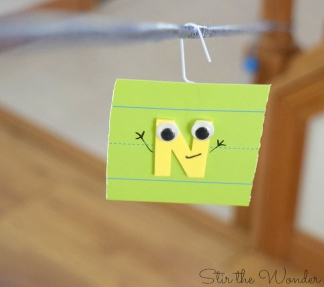 Notecard with a letter on it sliding down a homemade zipline (Letter Naming Fluency)