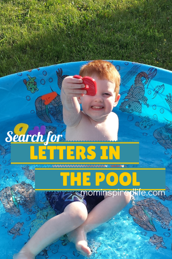 Kiddie pool games can use waterproof materials like the letters shown being held by a little boy in a blue kiddie pool. 